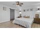 Bright main bedroom with ceiling fan, and barn door to the bathroom at 8036 N 17Th Dr, Phoenix, AZ 85021