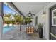 Covered outdoor living area features stone floors and ample seating overlooking a sparkling pool at 8036 N 17Th Dr, Phoenix, AZ 85021