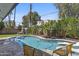 Backyard oasis features a private pool, lounge chairs, and lush tropical landscaping at 8036 N 17Th Dr, Phoenix, AZ 85021