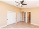 Neutral bedroom features a ceiling fan, fresh paint, wood look floors and a door to the bathroom at 8616 E Diamond St, Scottsdale, AZ 85257