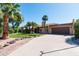 Charming single-story home featuring a well-maintained lawn, desert landscaping, and a spacious two-car garage at 8616 E Diamond St, Scottsdale, AZ 85257