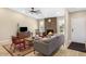 Cozy living room with stone fireplace, wood floors, and neutral walls at 8616 E Diamond St, Scottsdale, AZ 85257