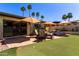 Outdoor space features patio seating, artificial turf, desert landscaping, and palm trees at 9012 S 47Th Pl, Phoenix, AZ 85044