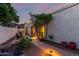 Cozy backyard retreat with a stone paver patio, mature trees, and decorative plants at 9012 S 47Th Pl, Phoenix, AZ 85044