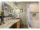 Bathroom featuring custom vanity, large mirror, and walk-in shower with beautiful neutral tile at 9012 S 47Th Pl, Phoenix, AZ 85044