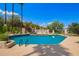 Sparkling community pool with inviting blue water, surrounded by lush landscaping and comfortable lounge chairs at 9012 S 47Th Pl, Phoenix, AZ 85044