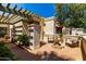 Inviting courtyard with a fountain, seating area, and lush greenery for outdoor relaxation at 9012 S 47Th Pl, Phoenix, AZ 85044