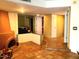 Spacious living area with rustic fireplace, tile floors, and open layout, creating a cozy and inviting atmosphere at 9012 S 47Th Pl, Phoenix, AZ 85044
