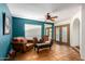 Inviting living room featuring tile floors, leather furniture and a decorative ceiling fan at 9012 S 47Th Pl, Phoenix, AZ 85044