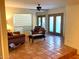Inviting living room with tile flooring and comfortable seating, bathed in natural light from the large window at 9012 S 47Th Pl, Phoenix, AZ 85044