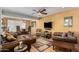 Spacious living room with TV, comfortable sofas and connecting dining area at 9012 S 47Th Pl, Phoenix, AZ 85044