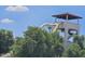 Waterpark slide partially obscured by foliage with a tower and people preparing to slide at 9012 S 47Th Pl, Phoenix, AZ 85044