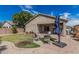 Landscaped backyard with a covered patio and a well-manicured lawn at 9463 W Ross Ave, Peoria, AZ 85382
