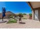 Inviting backyard features a brick patio, gravel landscaping, and a well-kept lawn at 9463 W Ross Ave, Peoria, AZ 85382