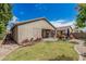 Landscaped backyard with a covered patio, lounge swing, well-maintained lawn, and tidy garden area at 9463 W Ross Ave, Peoria, AZ 85382