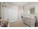 Bedroom features a closet, light wood floors, and a mirror over the dresser at 9463 W Ross Ave, Peoria, AZ 85382