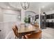 Elegant dining area with modern lighting, comfortable seating, and a view into the kitchen at 9463 W Ross Ave, Peoria, AZ 85382