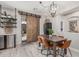 Charming dining room featuring a rustic table, stylish chairs, and a sliding barn door to the patio at 9463 W Ross Ave, Peoria, AZ 85382