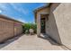 Cozy courtyard entrance with a charming front door and lush desert landscaping at 9463 W Ross Ave, Peoria, AZ 85382