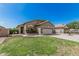 Inviting single-story home features a well-manicured lawn, desert landscaping, and a two-car garage at 9463 W Ross Ave, Peoria, AZ 85382