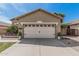 Single-story home features a two-car garage, desert landscaping, and low maintenance yard at 9463 W Ross Ave, Peoria, AZ 85382
