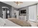Bedroom showcasing a dresser, TV, and access to the walk-in closet and ensuite bathroom at 9463 W Ross Ave, Peoria, AZ 85382