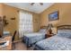Bedroom with two twin beds, a desk, and a window with sheer curtains at 10136 E Southern Ave # 2064, Mesa, AZ 85209