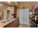 Cozy kitchen features stainless steel sink, wood cabinets, and modern appliances at 10136 E Southern Ave # 2064, Mesa, AZ 85209