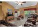 Comfortable living room with plush leather furniture, a ceiling fan and access to the outdoor patio at 10136 E Southern Ave # 2064, Mesa, AZ 85209