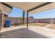 Covered patio in a spacious backyard with block fence and desert landscaping at 119 E Hampton Ave, Mesa, AZ 85210