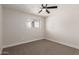 Bedroom features neutral carpet, ceiling fan, and natural light at 119 E Hampton Ave, Mesa, AZ 85210