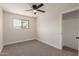 Bedroom features neutral carpet, ceiling fan, and natural light at 119 E Hampton Ave, Mesa, AZ 85210