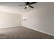 Spacious bedroom with neutral carpet, ceiling fan, and natural light at 119 E Hampton Ave, Mesa, AZ 85210