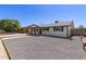 Charming single-story home featuring gravel landscaping, a covered front porch, and fresh exterior paint at 119 E Hampton Ave, Mesa, AZ 85210