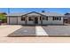 Charming home featuring a gravel yard, brick-accented posts, and a welcoming front entrance at 119 E Hampton Ave, Mesa, AZ 85210