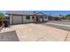 Exterior view of home with a large concrete driveway and easy garage access at 119 E Hampton Ave, Mesa, AZ 85210