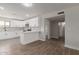 Open kitchen featuring white cabinets, marble backsplash, stainless steel appliances, and breakfast bar at 119 E Hampton Ave, Mesa, AZ 85210