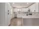 Bright kitchen boasts white cabinets, stainless steel appliances, marble backsplash, and quartz countertops at 119 E Hampton Ave, Mesa, AZ 85210