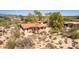 Desert home with a terracotta roof, natural landscaping, and mature trees in an arid environment at 1305 Coyote Pass Pass, Carefree, AZ 85377