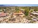 Sprawling desert home, with terracotta roof and mature trees, surrounded by desert landscaping and mountain views at 1305 Coyote Pass Pass, Carefree, AZ 85377