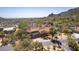 Expansive aerial view showcasing a desert home with a terracotta roof nestled in a lush desert landscape at 1305 Coyote Pass Pass, Carefree, AZ 85377