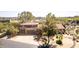 Tile roof home with desert vegetation, and three-car garage, captured from above at 1305 Coyote Pass Pass, Carefree, AZ 85377