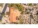 Aerial view of a desert home with a terracotta tile roof and circular patio at 1305 Coyote Pass Pass, Carefree, AZ 85377