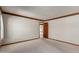 Carpeted bedroom offers bright views with wood trim, white walls and open door leading to another part of the house at 1305 Coyote Pass Pass, Carefree, AZ 85377