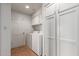 Bright laundry room with white appliances and storage cabinets at 1305 Coyote Pass Pass, Carefree, AZ 85377