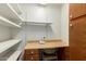 Small office with wooden desk and built in shelving at 1305 Coyote Pass Pass, Carefree, AZ 85377