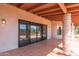 Covered patio featuring tile flooring, textured pillars, and access to the backyard at 1305 Coyote Pass Pass, Carefree, AZ 85377