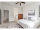 Serene primary bedroom with a ceiling fan, soft decor, and an ensuite bathroom in view at 13569 S 175Th Dr, Goodyear, AZ 85338