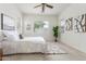 Inviting bedroom with a ceiling fan, plush rug, and plenty of natural light from large windows at 13569 S 175Th Dr, Goodyear, AZ 85338