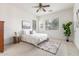 Bright bedroom with neutral decor, ceiling fan, and ample natural light from large windows at 13569 S 175Th Dr, Goodyear, AZ 85338